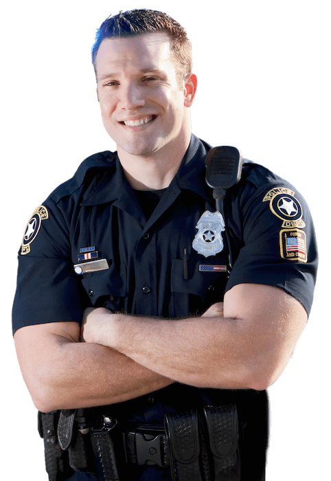 A photograph of a police officer with light skin, smiling broadly, with his arms crossed across his chest